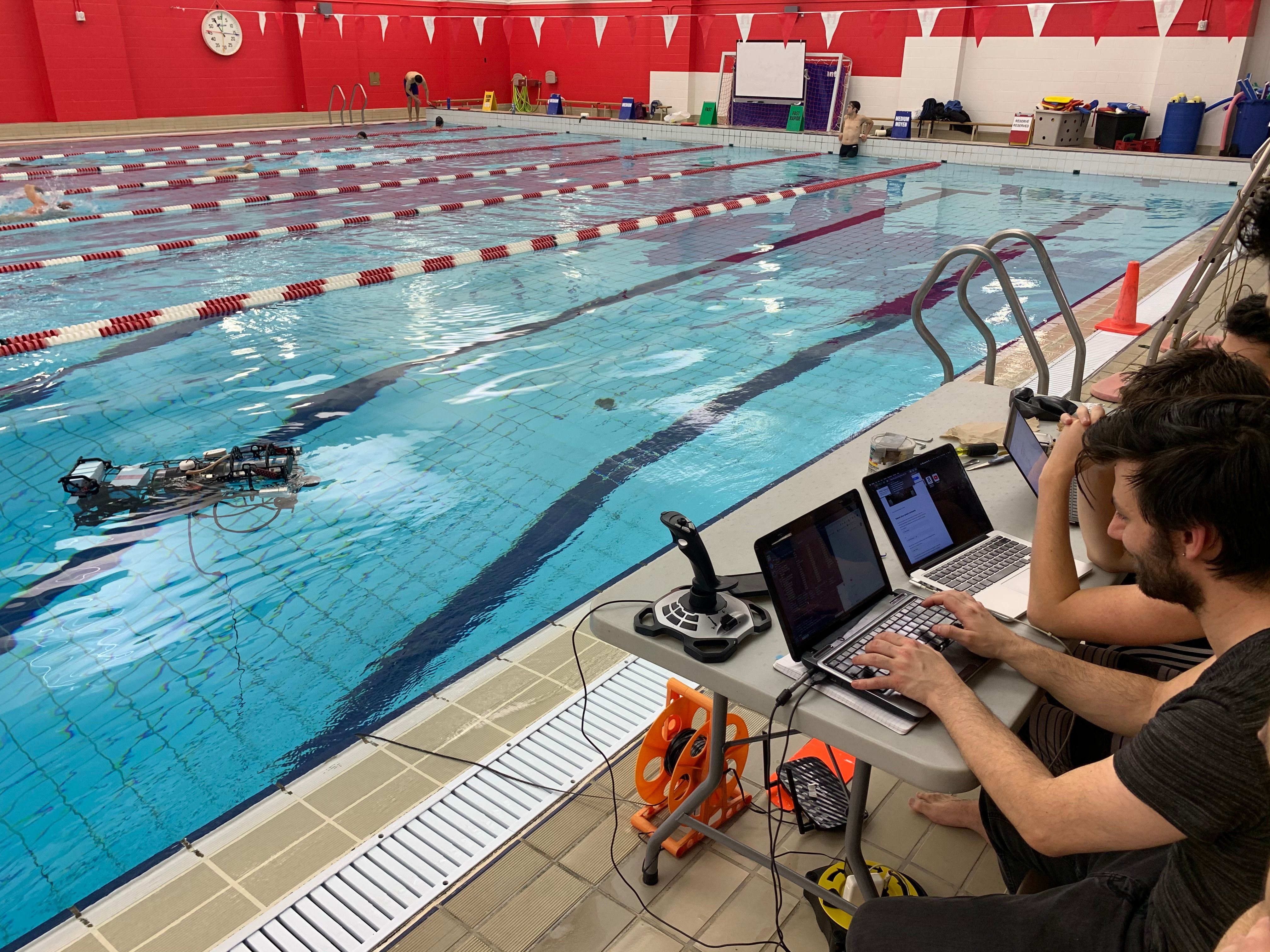 Debugging the AUV at the side of the pool. No laptops were harmed.